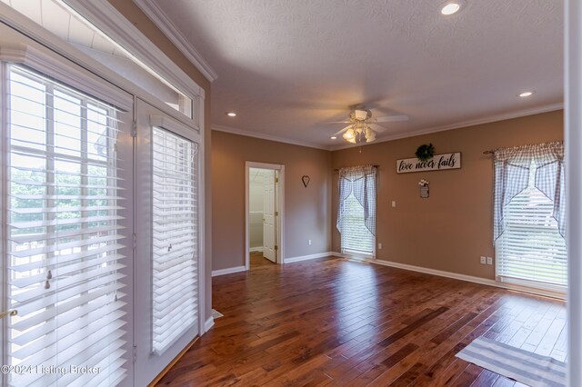 interior space featuring hardwood / wood-style floors, ceiling fan, plenty of natural light, and ornamental molding