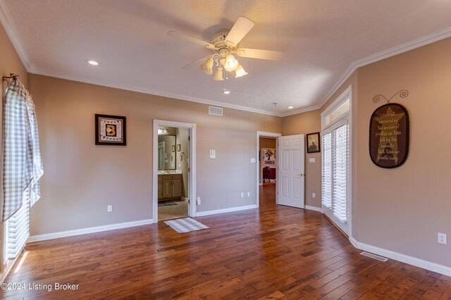 unfurnished living room with ceiling fan, dark hardwood / wood-style floors, and ornamental molding