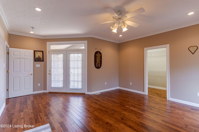 interior space featuring ceiling fan, dark hardwood / wood-style floors, and crown molding