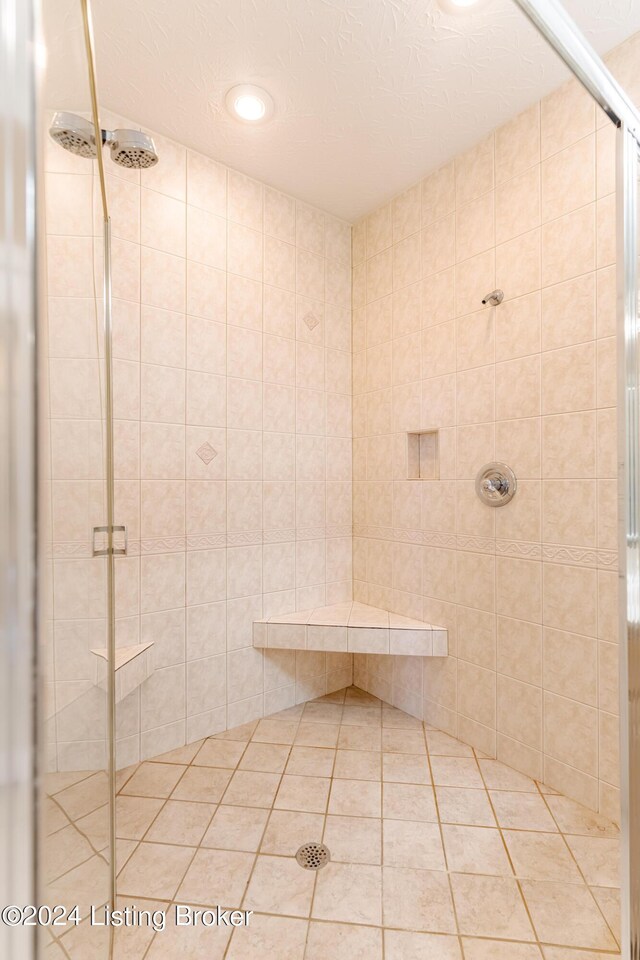 bathroom featuring an enclosed shower and a textured ceiling