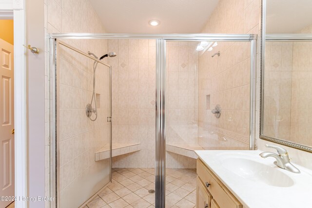 bathroom with vanity and a shower with shower door