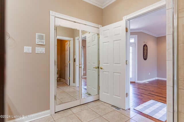 interior space featuring ornamental molding and light tile patterned floors