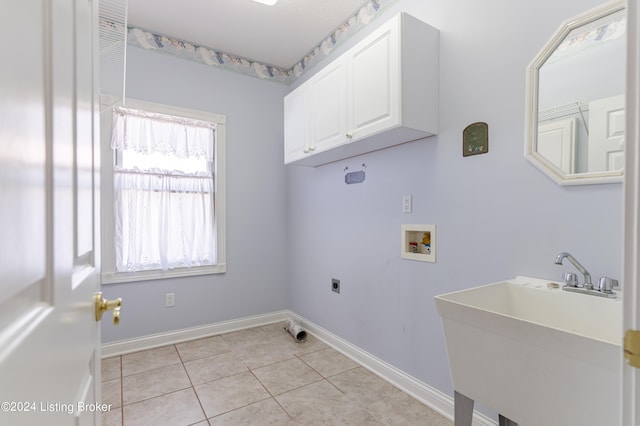 washroom featuring cabinets, electric dryer hookup, hookup for a washing machine, light tile patterned floors, and sink