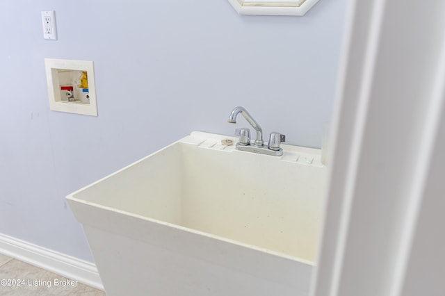 laundry room featuring hookup for a washing machine, light tile patterned flooring, and sink