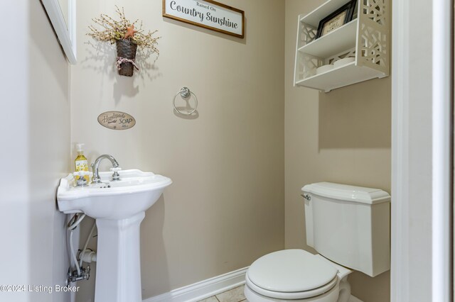 bathroom with toilet and tile patterned floors