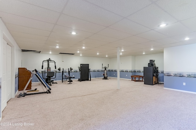 exercise area with carpet flooring and a drop ceiling