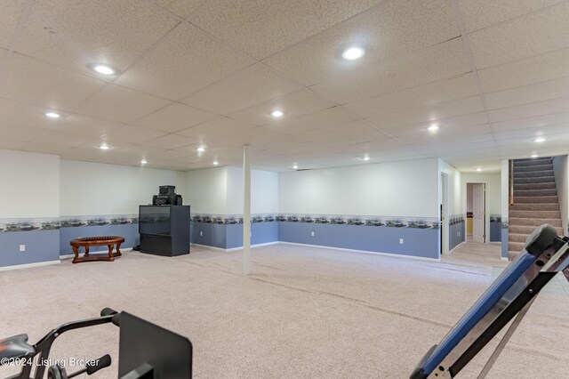 playroom featuring carpet flooring and a paneled ceiling