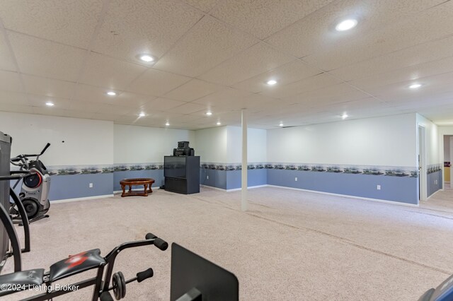 workout room with carpet and a drop ceiling