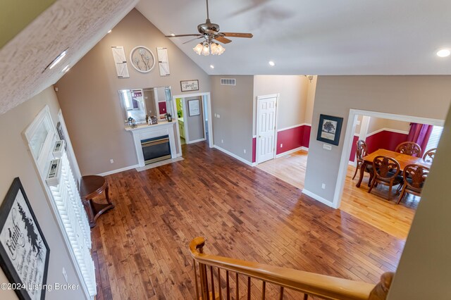 living room featuring high vaulted ceiling, hardwood / wood-style floors, and ceiling fan