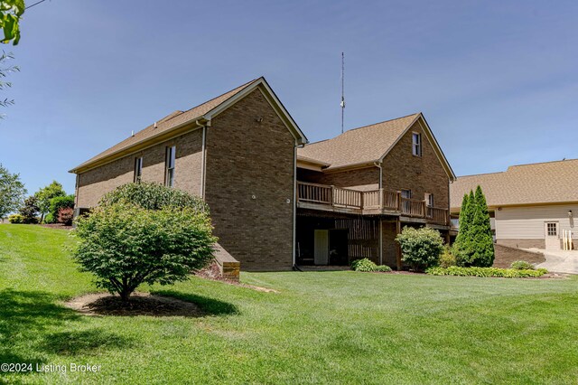 rear view of property with a yard