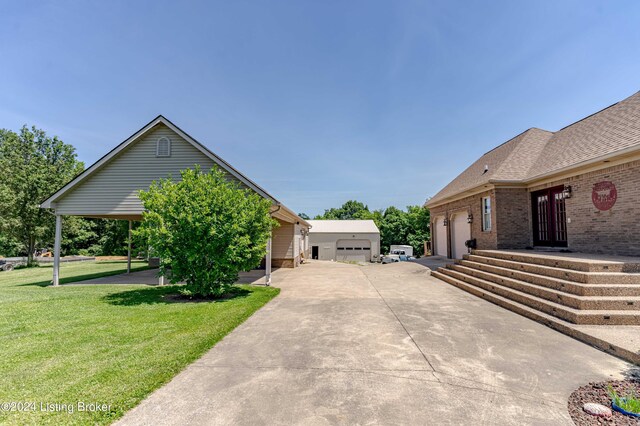 view of side of home with a yard, a garage, and a carport