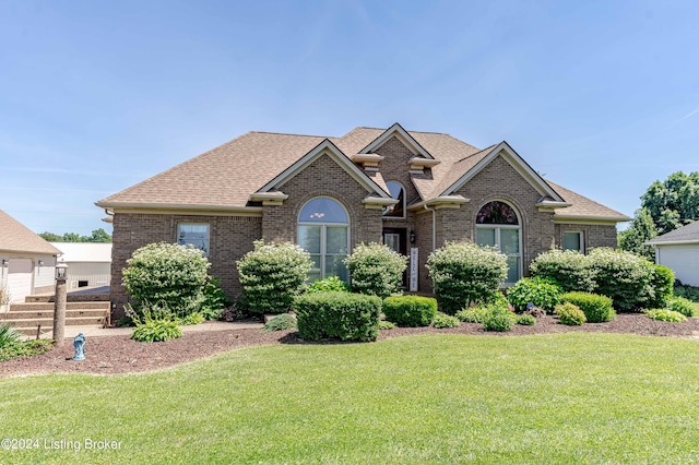 view of front facade with a front lawn and a garage