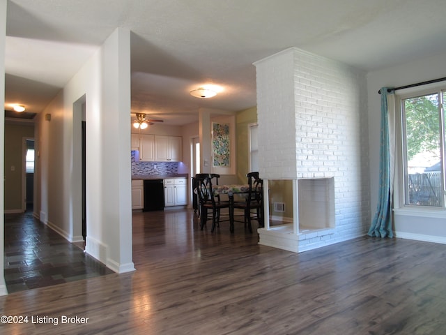 interior space with ceiling fan and dark hardwood / wood-style floors