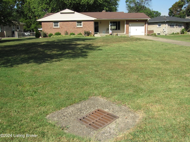 single story home featuring a garage and a front lawn