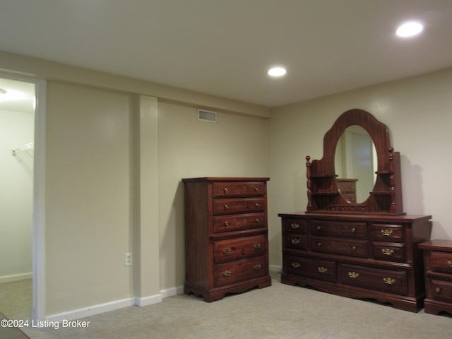 carpeted bedroom featuring a closet and a walk in closet