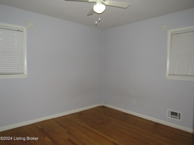 empty room featuring ceiling fan and dark hardwood / wood-style floors