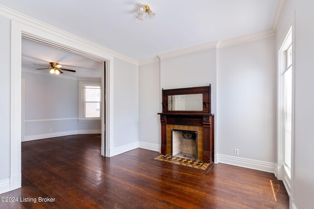 unfurnished living room featuring a tile fireplace, ornamental molding, dark hardwood / wood-style flooring, and ceiling fan