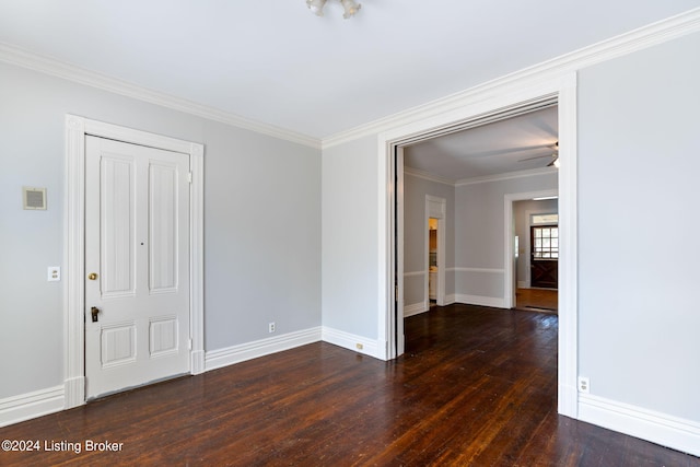 unfurnished room featuring crown molding and dark hardwood / wood-style flooring