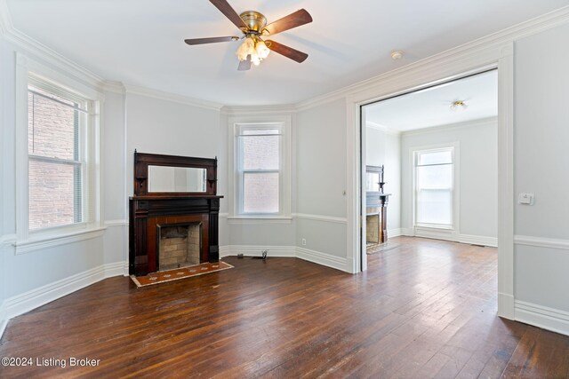 unfurnished living room with ceiling fan, crown molding, and dark wood-type flooring