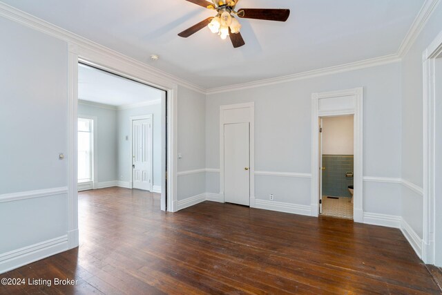 unfurnished bedroom featuring ornamental molding, dark wood-type flooring, and ceiling fan