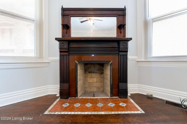 details with ceiling fan and a fireplace