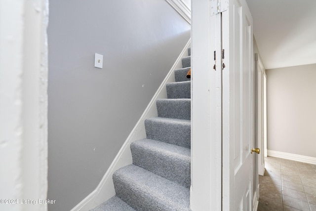 staircase with tile patterned floors