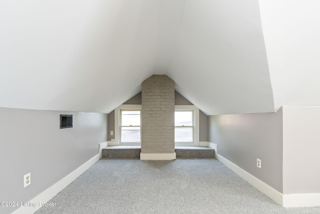 bonus room featuring carpet flooring and vaulted ceiling