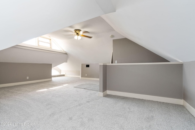 additional living space featuring vaulted ceiling, ceiling fan, and light colored carpet