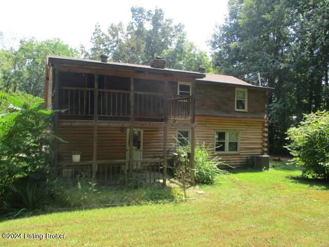 rear view of property featuring a yard and log exterior