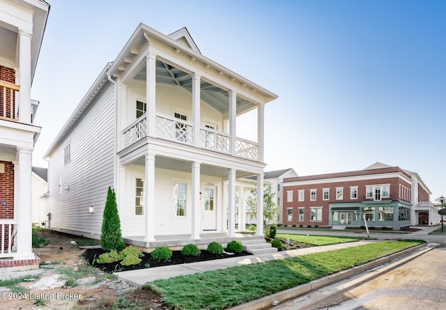 greek revival house with a balcony and a porch