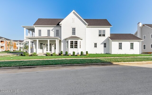 view of front of house featuring a front lawn and covered porch