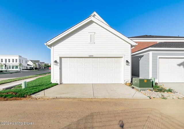 exterior space with cooling unit and a garage