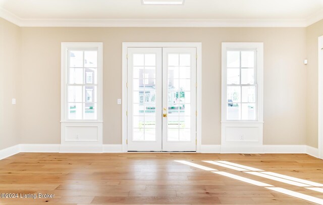 doorway featuring light hardwood / wood-style flooring, ornamental molding, and french doors