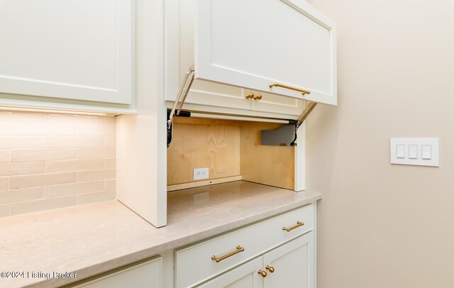 kitchen featuring backsplash and white cabinets