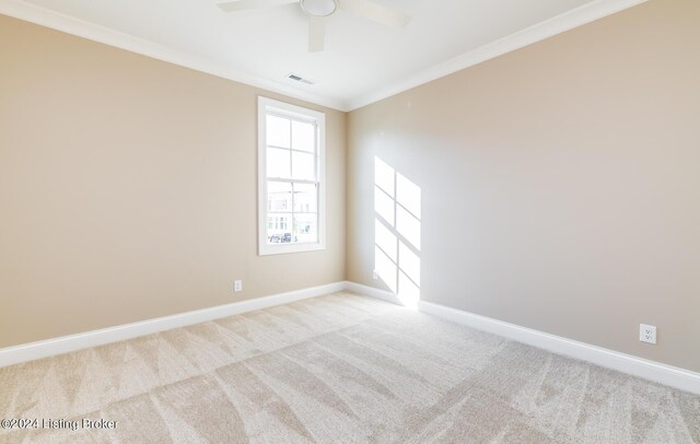 unfurnished room featuring crown molding, light carpet, and ceiling fan