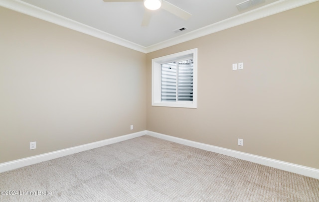 empty room featuring crown molding, ceiling fan, and carpet flooring