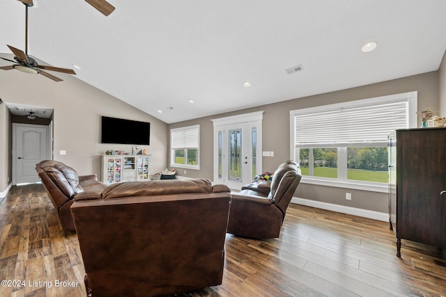 living room with lofted ceiling, dark wood-style flooring, a ceiling fan, and baseboards