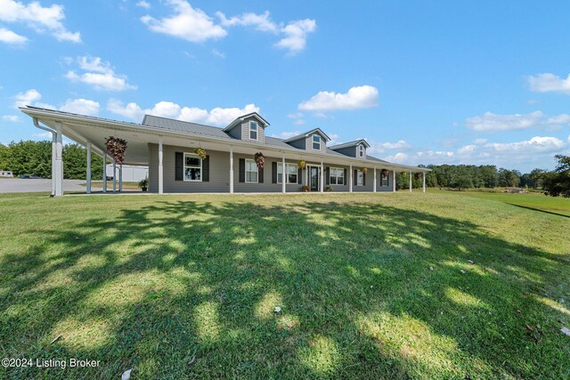 farmhouse featuring a front lawn and a carport