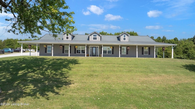 country-style home with metal roof, an attached carport, a porch, and a front yard