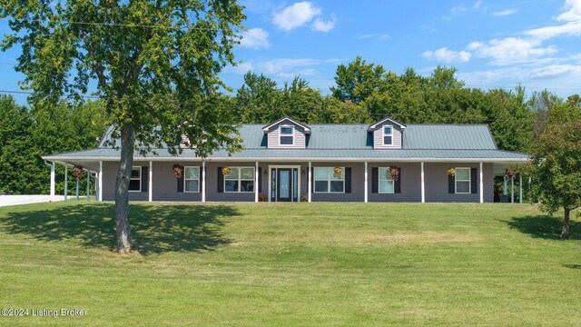 farmhouse featuring a porch and a front lawn