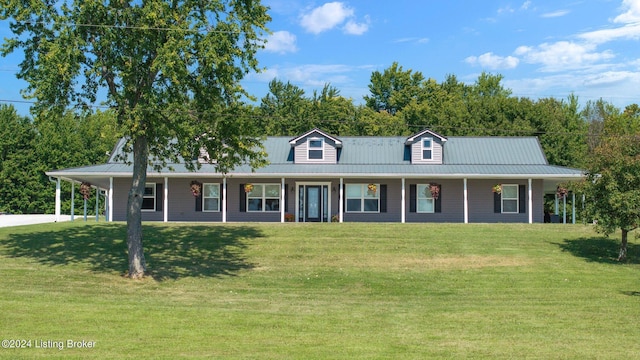 farmhouse inspired home with driveway, a front yard, metal roof, and an attached carport