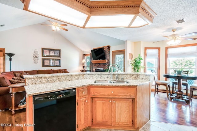 kitchen featuring light hardwood / wood-style flooring, ceiling fan, black dishwasher, and sink