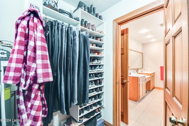 walk in closet featuring light tile patterned flooring