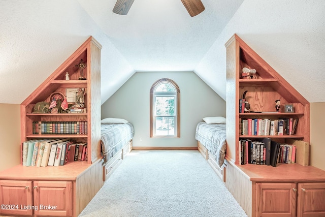 carpeted bedroom featuring ceiling fan, vaulted ceiling, and a textured ceiling