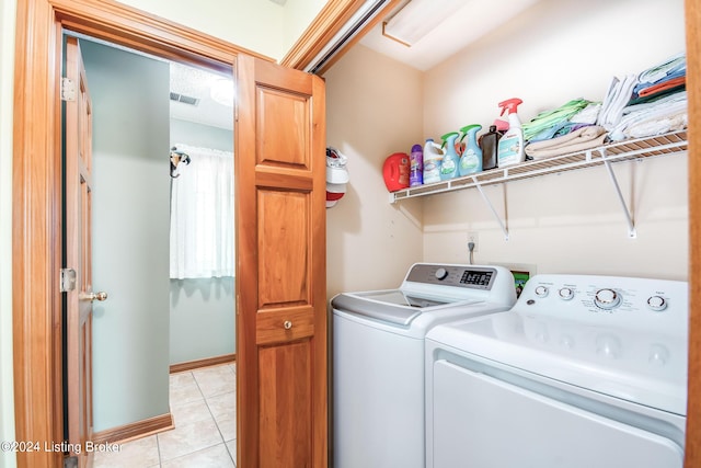 laundry room with light tile patterned floors and independent washer and dryer