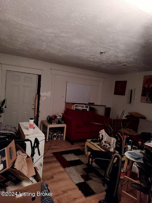 living room featuring hardwood / wood-style flooring and a textured ceiling