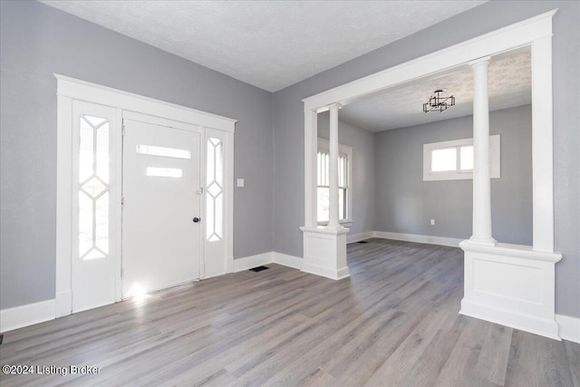 entryway featuring a textured ceiling and light wood-type flooring