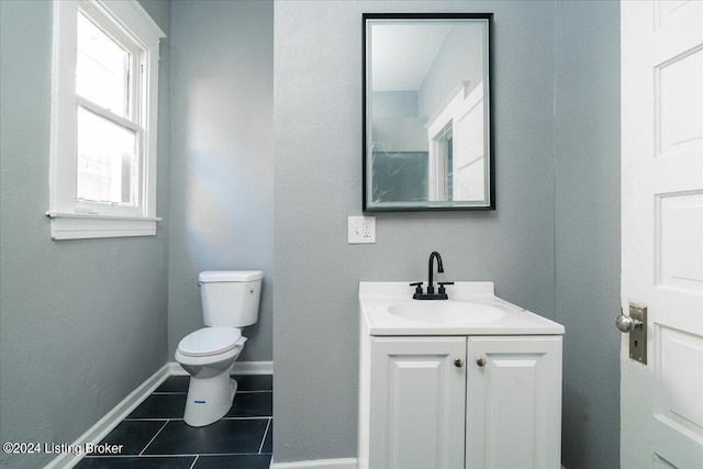 bathroom with vanity, toilet, and tile patterned floors