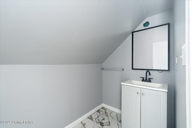 bathroom with vanity and lofted ceiling