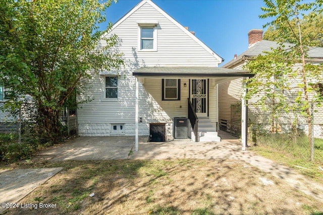 back of house with cooling unit and covered porch